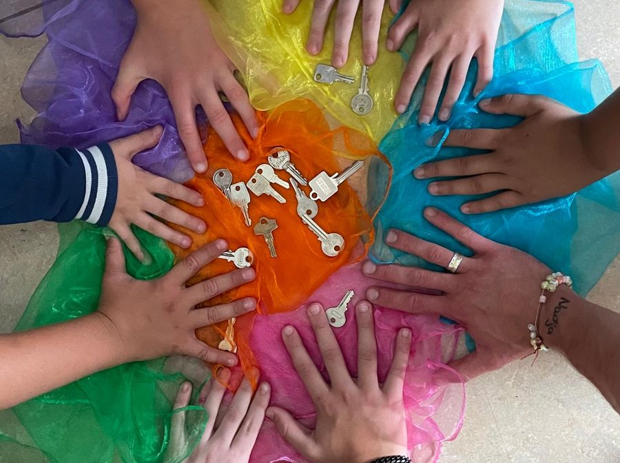 Kinderhände auf bunten Tüchern bei einer Achtsamkeitsübung in der Schule